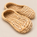 Handwoven Cattail Grass Slippers, House Shoes for Women, Eco-Friendly Indoor Sandals on a beige backdrop