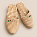 Handmade Woven Straw Slippers: Eco-Friendly Unisex Spa Shoes on a beige backdrop