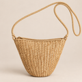 Mini Straw Crossbody Bag, Small Woven Basket Purse with Zip Top, Boho Summer Sling Bag for Sundress, Travel and Beach on a beige backdrop