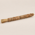 Natural Grass Chew Stick for Dogs: Handwoven Puppy Teething Toy on a beige backdrop