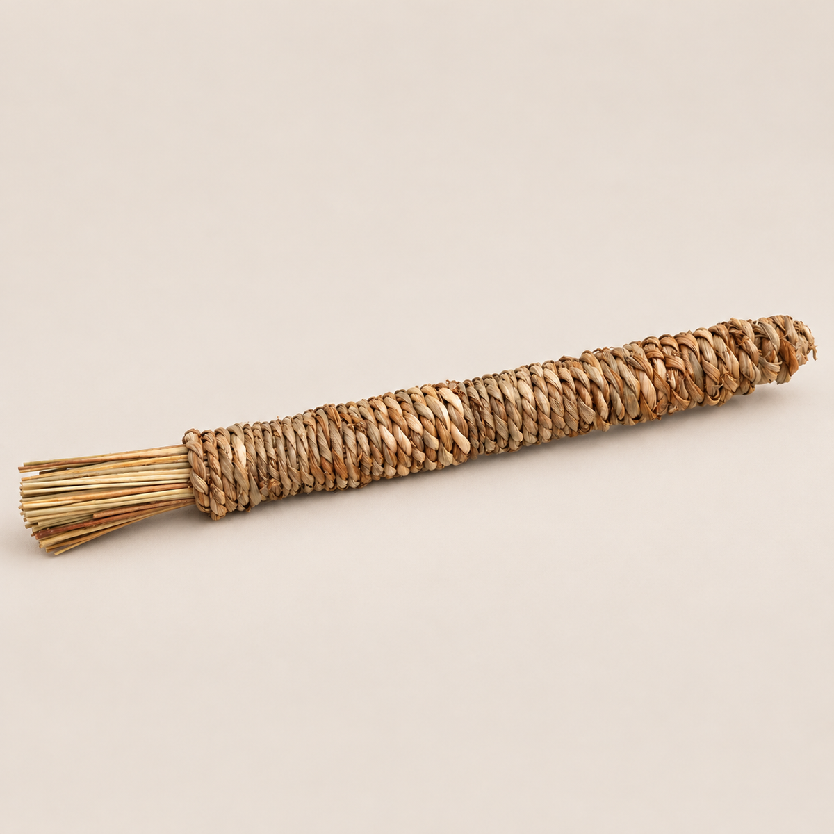 Natural Grass Chew Stick for Dogs: Handwoven Puppy Teething Toy on a beige backdrop