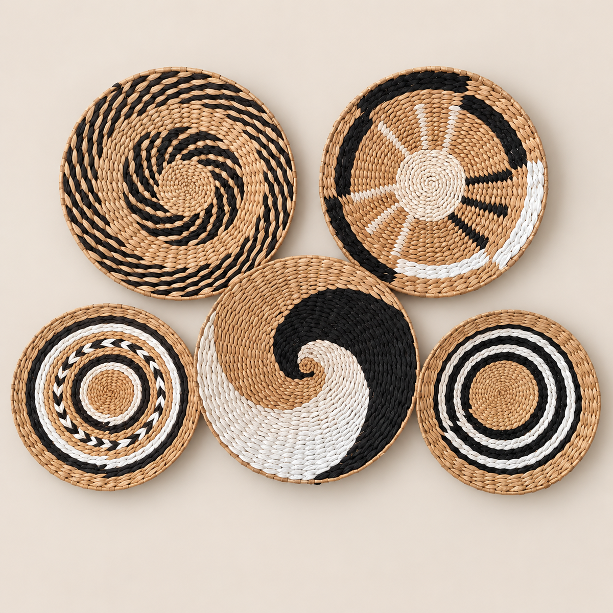 Woven Wall Basket Set of 5, Handmade Cattail Boho Wall Art in Black White and Natural, Round Wall Decor for Bedroom on a beige backdrop