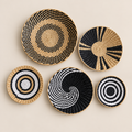 Handmade Woven Wall Basket Set of 5, Boho Wall Decor, Black and White Cattail Wall Hanging on a beige backdrop
