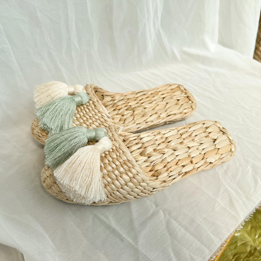 Pair of handmade straw slippers with closed toe and wide woven upper, decorated with three large tassels in cream, mint green, and white. Natural beige color, lightweight and breathable. - view 2