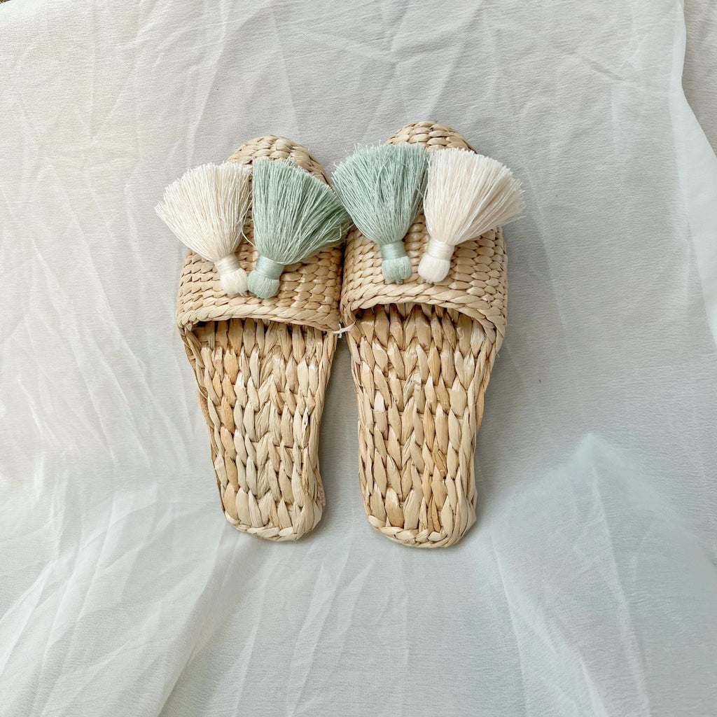 Pair of handmade straw slippers with closed toe and wide woven upper, decorated with three large tassels in cream, mint green, and white. Natural beige color, lightweight and breathable. - view 3