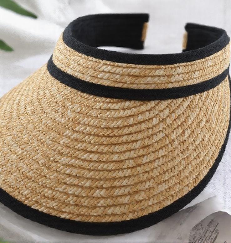 Straw sun hat visor with a wide brim and black trim, shown close up on a white background. Lightweight and stylish summer cap for beach, outdoor UV protection, vacation, honeymoon, garden, or as a thoughtful gift for her mom.