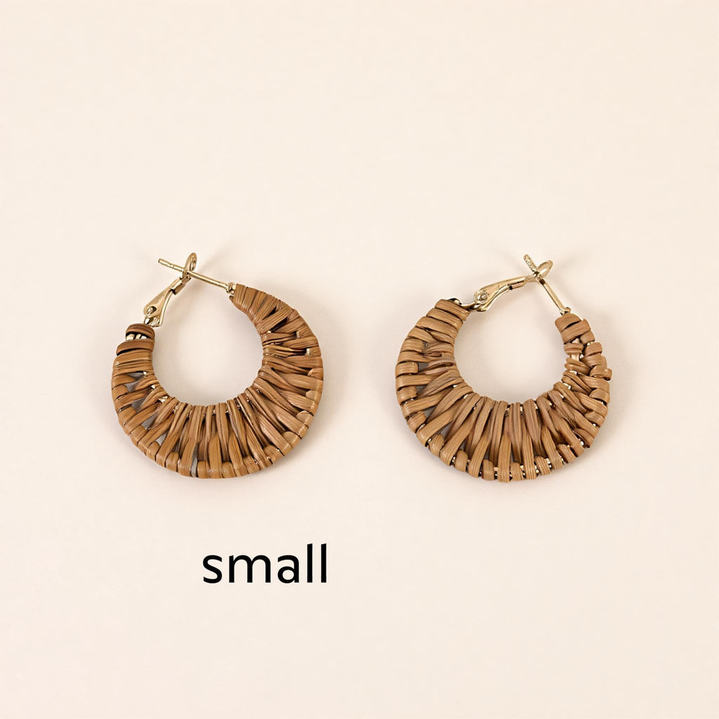 Two small, brown woven earrings are displayed against a light background.
