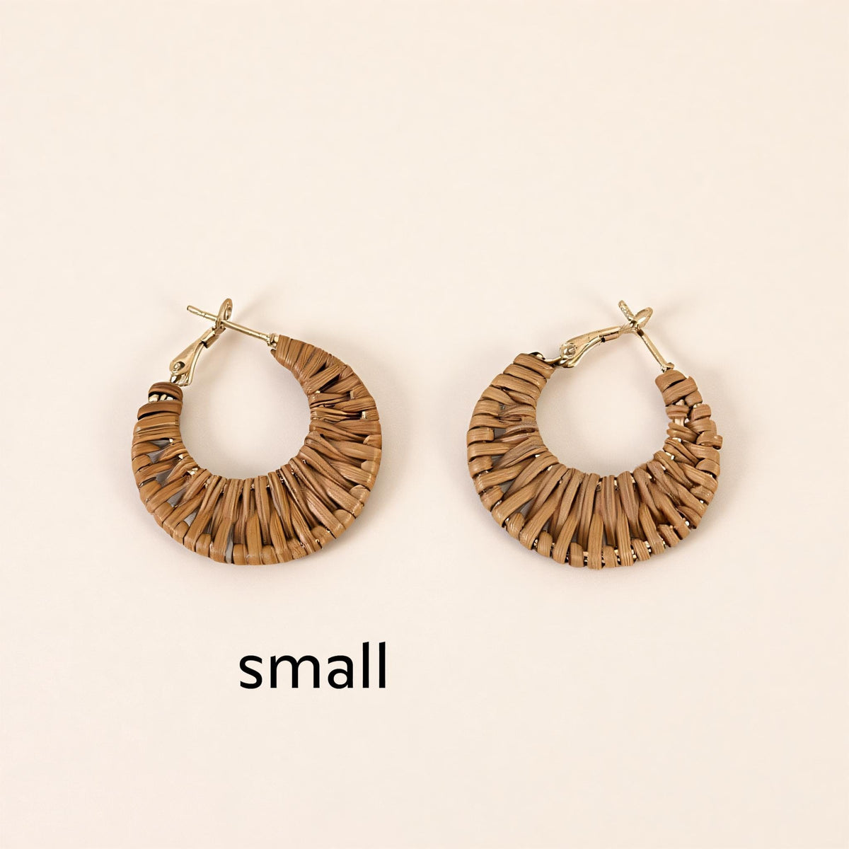 Two small, brown woven earrings are displayed against a light background.