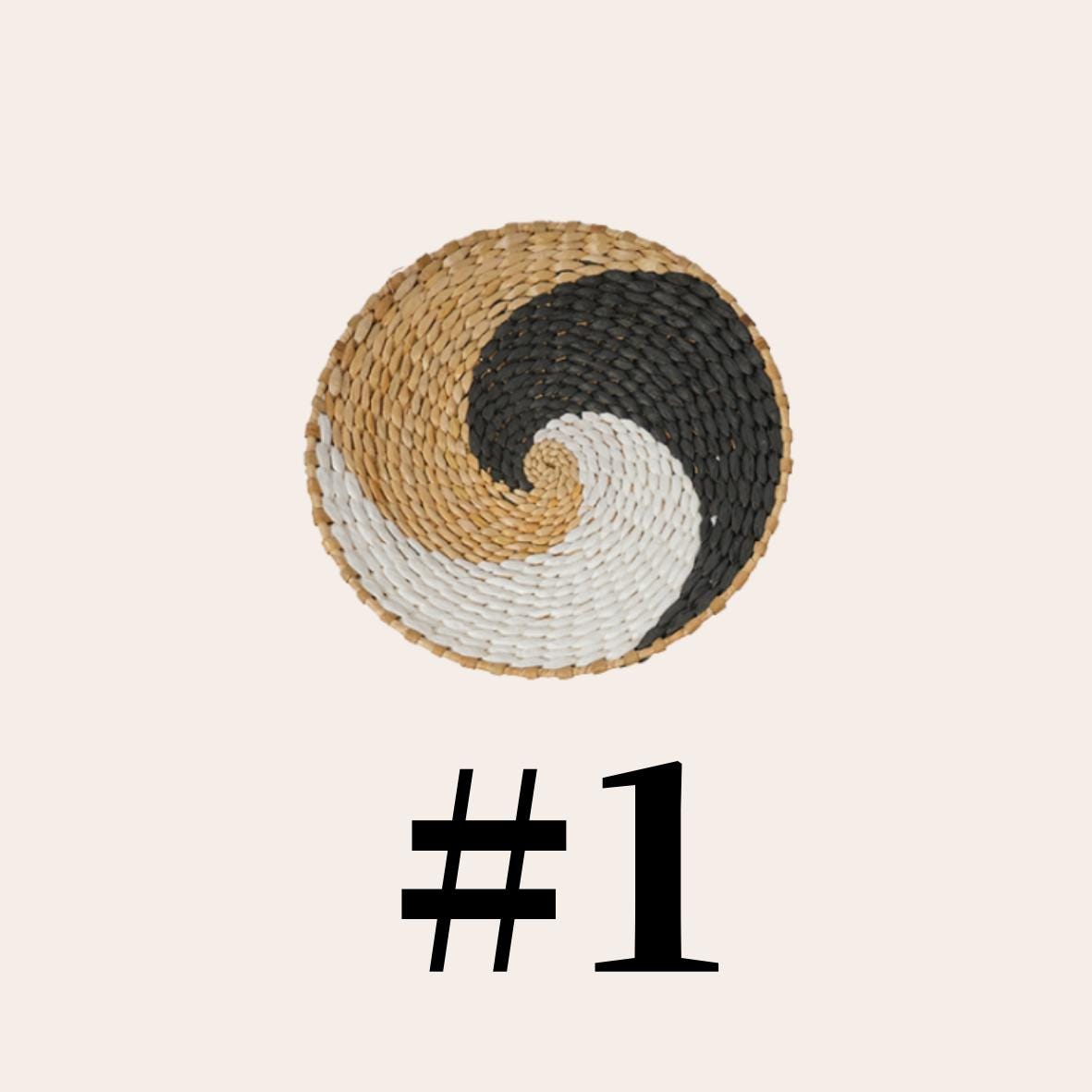 a woven basket with a spiral pattern in black, white, and brown colors.