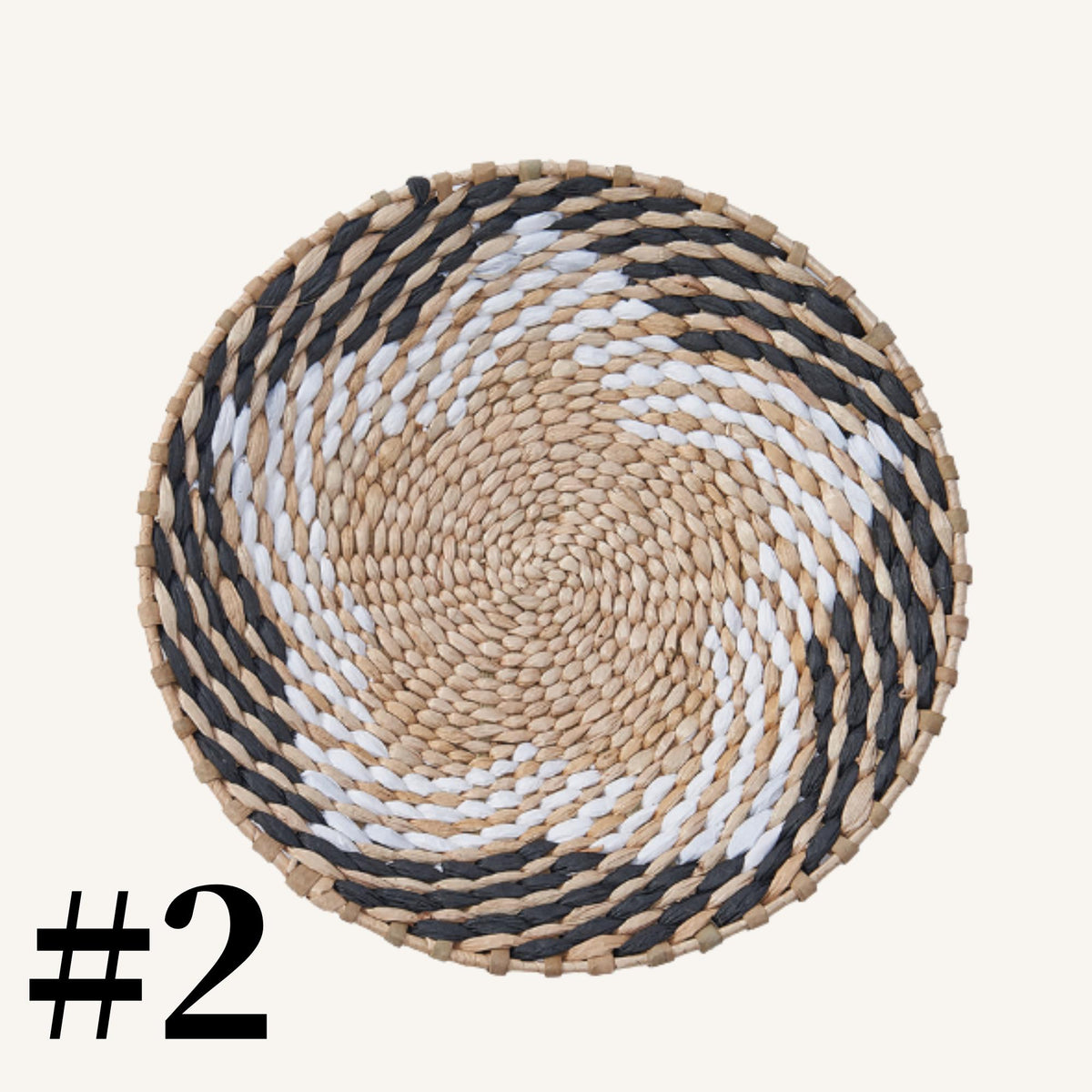 A woven basket with a spiral pattern in black, white, and beige colors.
