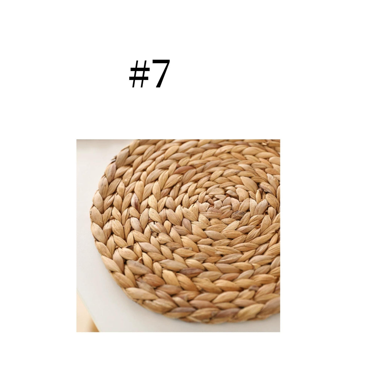 a close-up view of a woven mat or coaster made of natural materials, such as straw or reeds, arranged in a circular pattern.