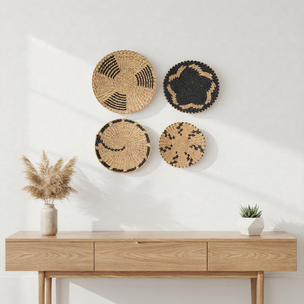 a wooden console table with four decorative baskets hanging on the wall above it. The baskets have a mix of black and brown colors, and the table is set against a white wall. There is also a potted plant on the table, adding a touch of greenery to the scene.