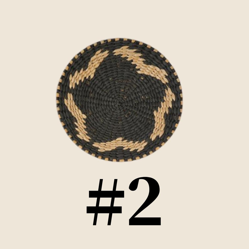 a black and white woven basket with a star-shaped pattern on it.