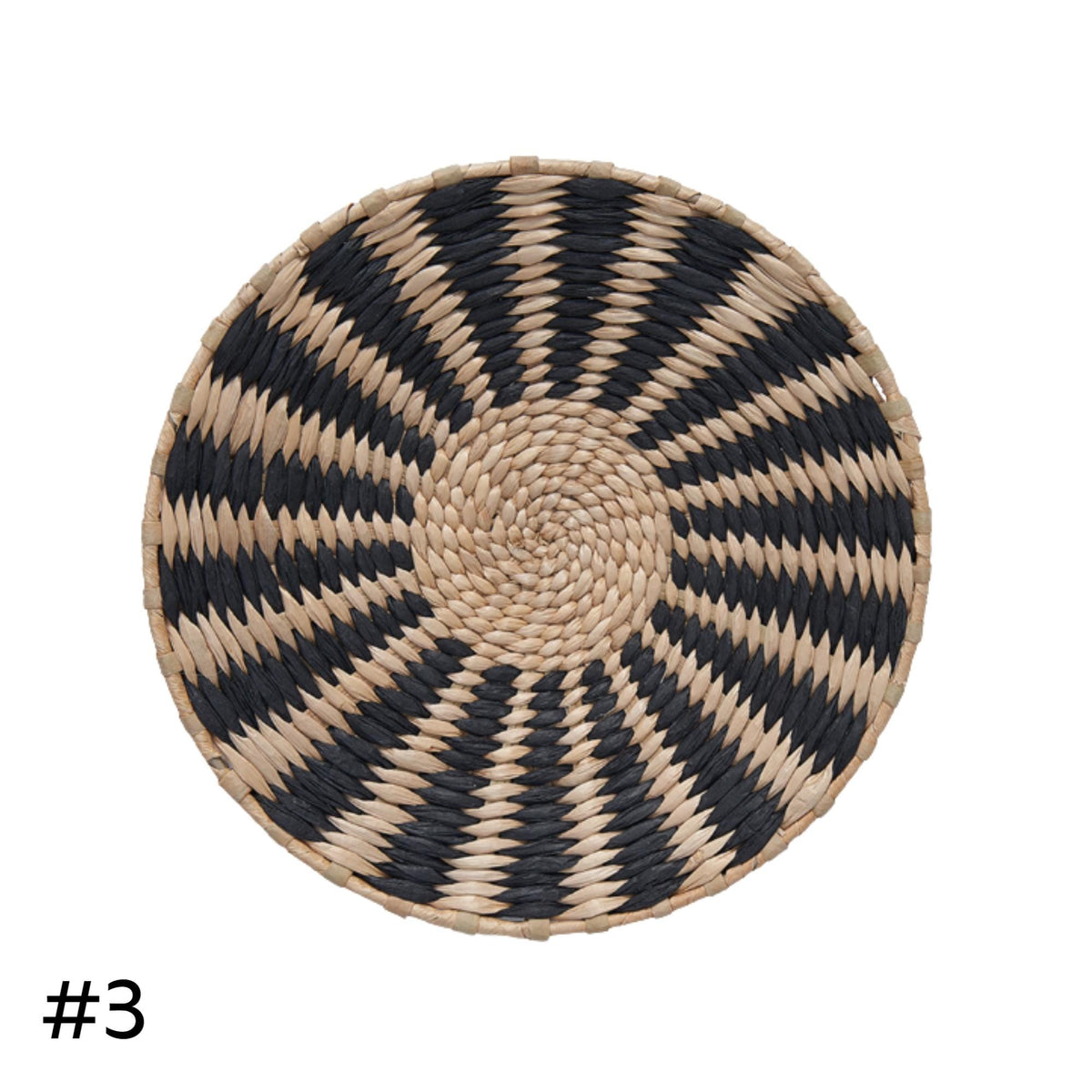 A round woven basket with a black and white striped pattern.