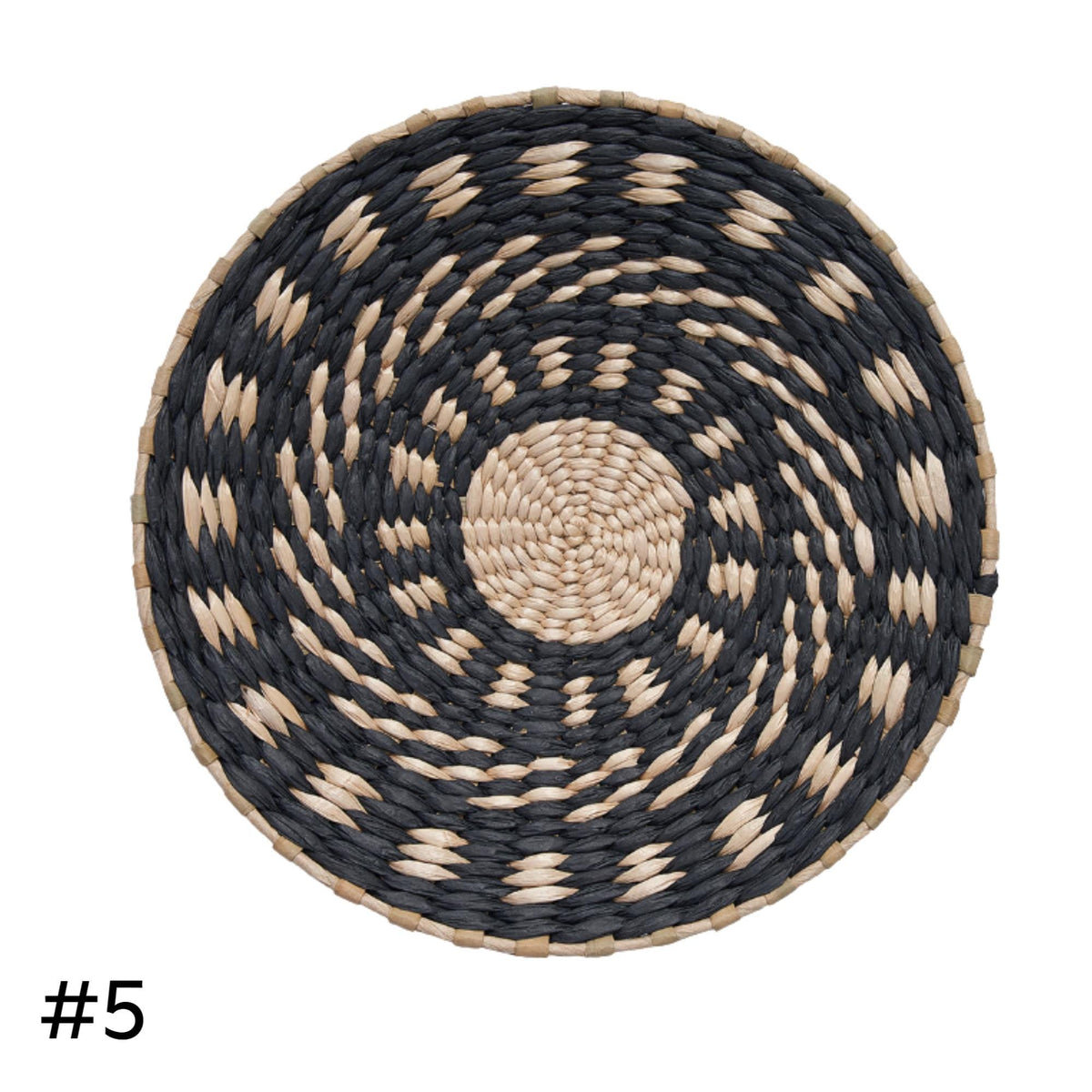 a round woven basket with a black and white spiral pattern.