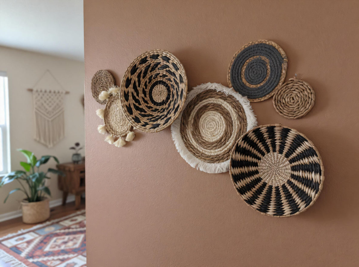 a wall adorned with a collection of woven baskets and plates, creating a visually appealing and textured display.