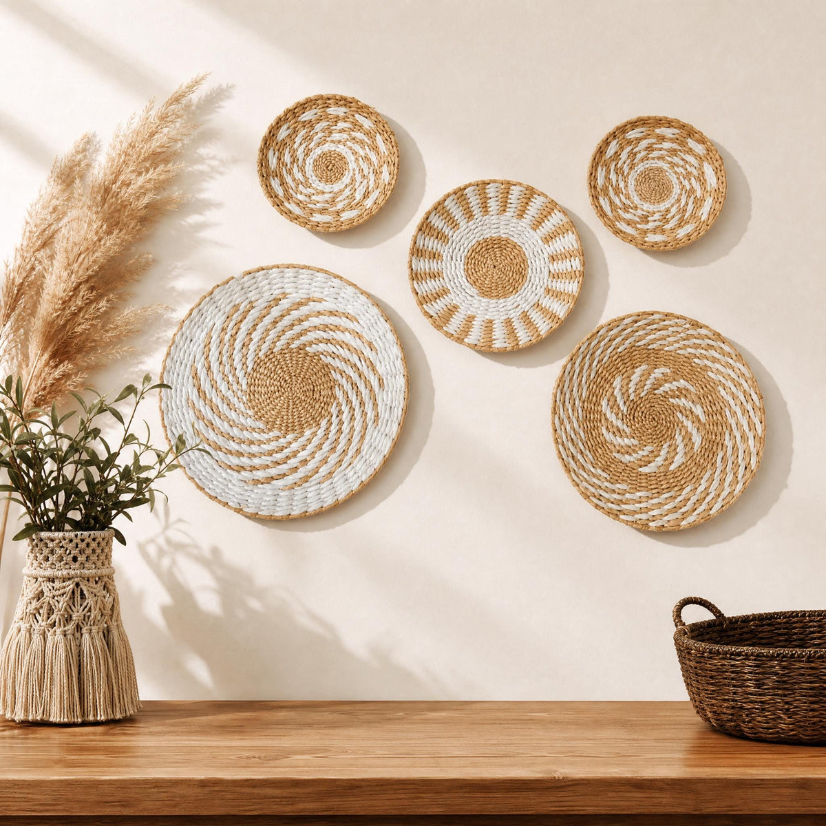 a wooden table with a woven basket and a vase of dried flowers, set against a white wall with six woven baskets and plates arranged in a row.