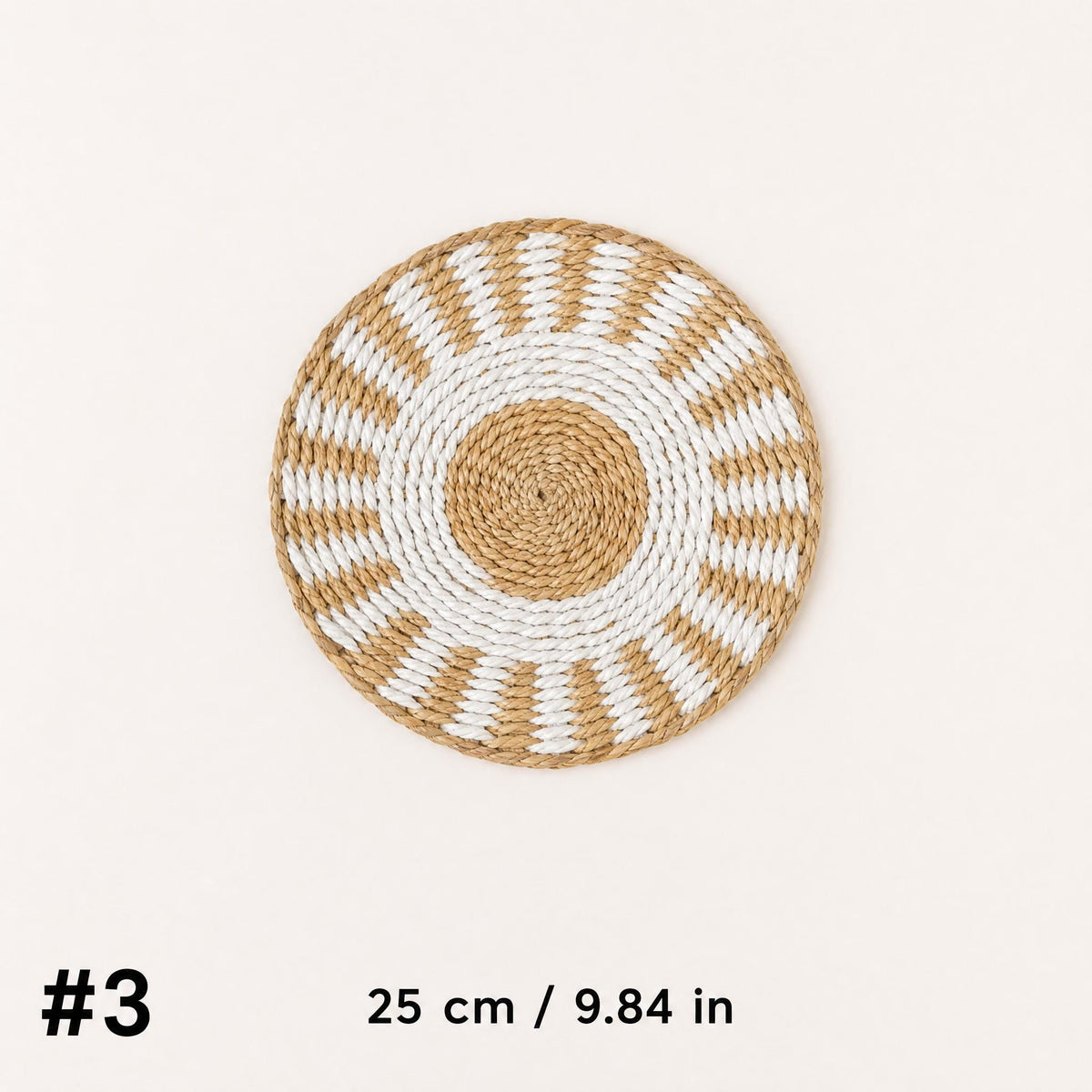 A woven mat with a sunburst design, placed against a white background.