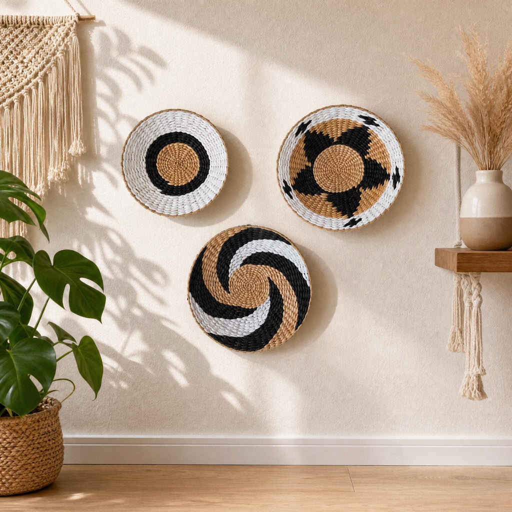 three decorative baskets hanging on a wall, with a potted plant and a woven basket on the floor to the left.
