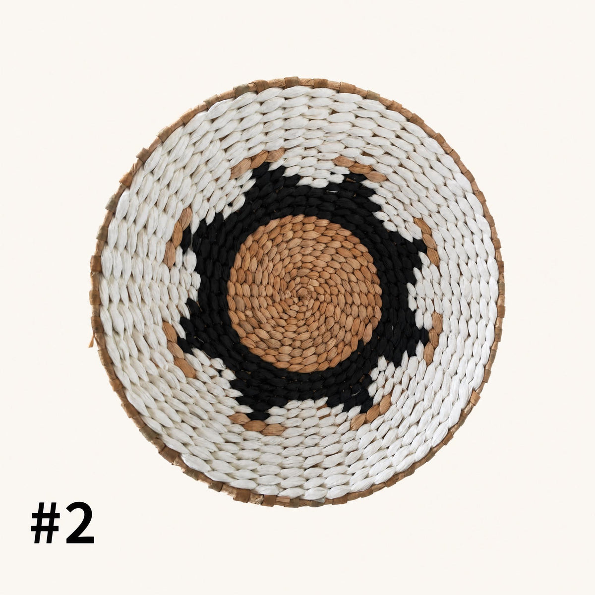 a woven basket with a black and white pattern around the center.