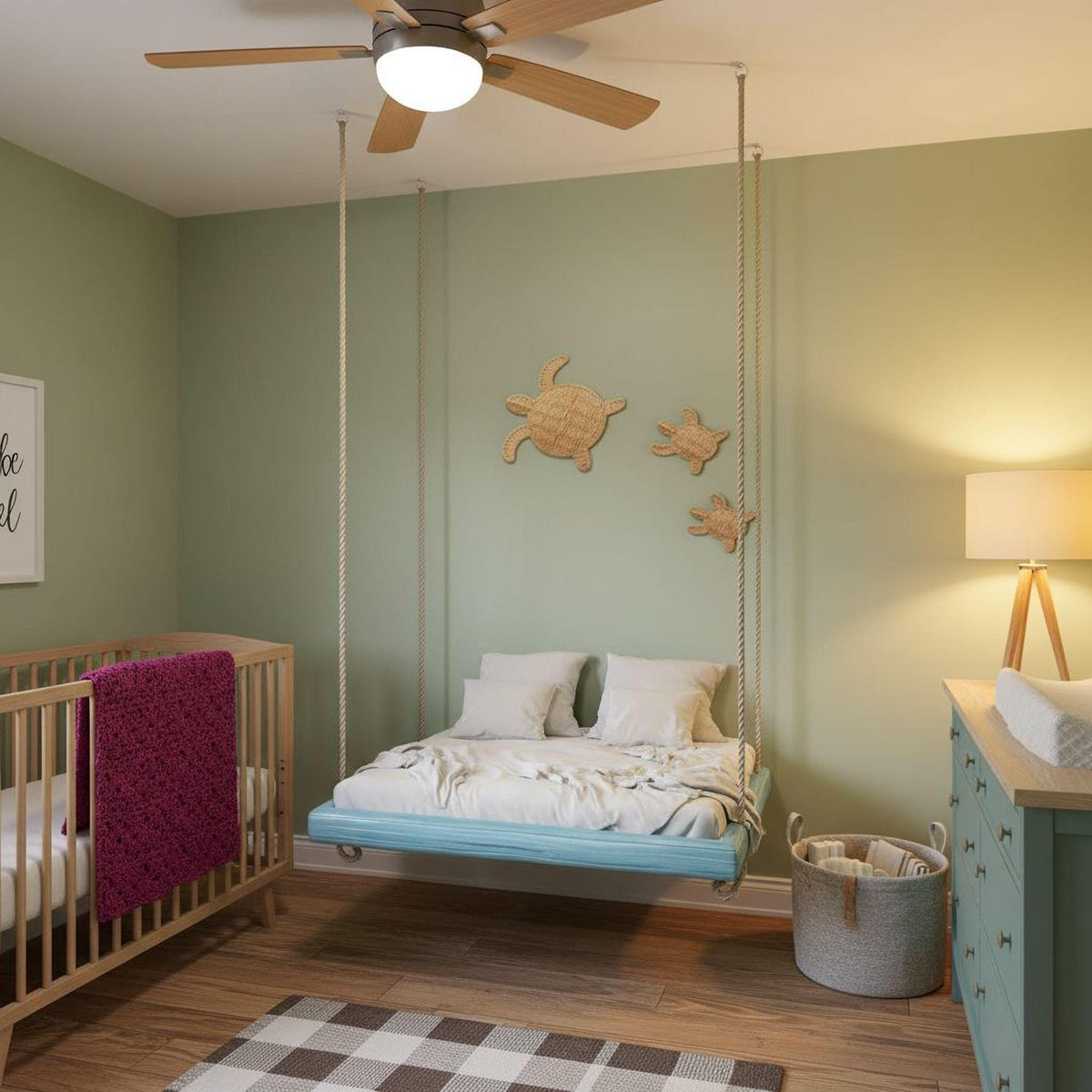 a cozy nursery room with a crib, a bed with a blue frame, and a hanging swing. The room has a soothing green color scheme and features a ceiling fan and a wooden wall decoration.