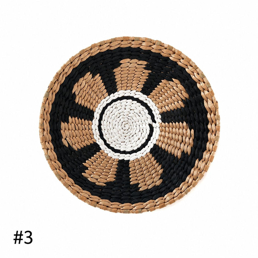 A woven basket with a black and white circular design in the center.