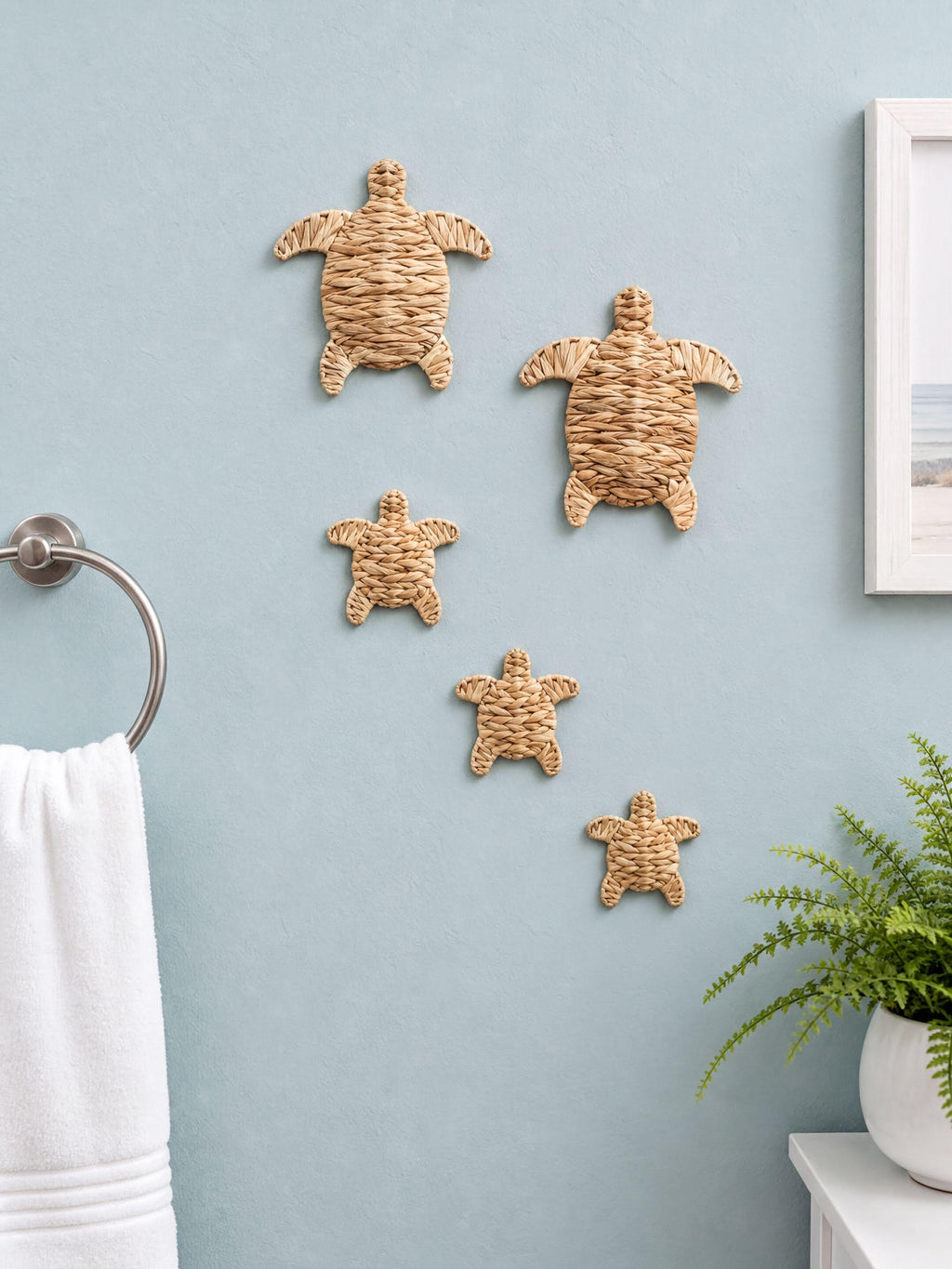 a bathroom wall decorated with a collection of five woven turtle-shaped wall hangings in various sizes, creating a playful and coastal aesthetic.