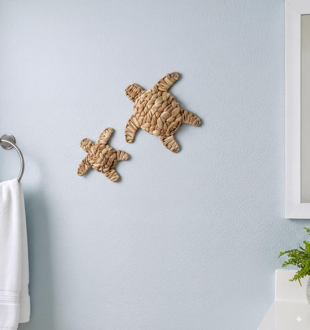 two small, intricately woven turtle-shaped wall decorations on a light blue wall.