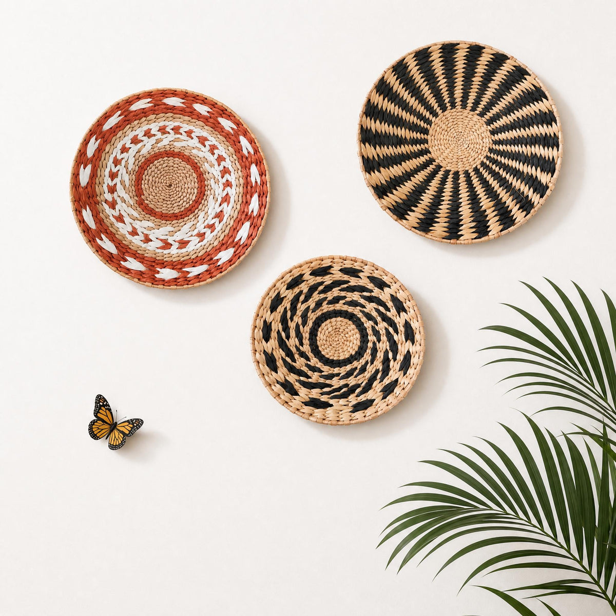 three decorative woven baskets hanging on a white wall, with a small butterfly resting on the left side of the image.