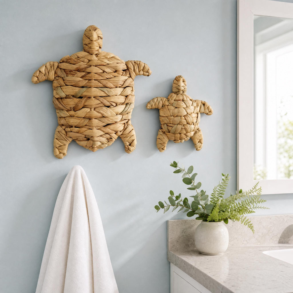 a bathroom with a towel rack, a small vase with greenery, and two wall decorations shaped like turtles.