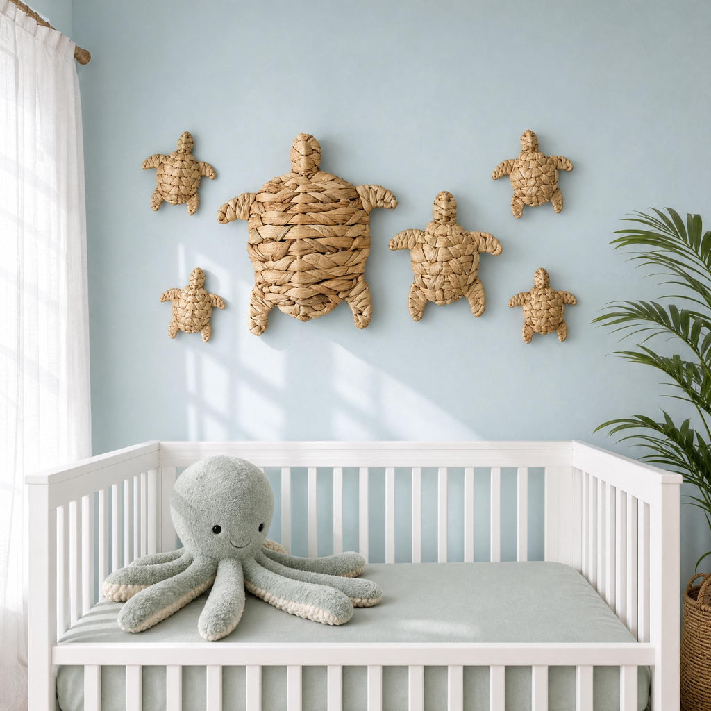 A white crib with a gray stuffed octopus toy on top, and six small turtle-shaped wall decorations above it, creating a nautical-themed nursery.