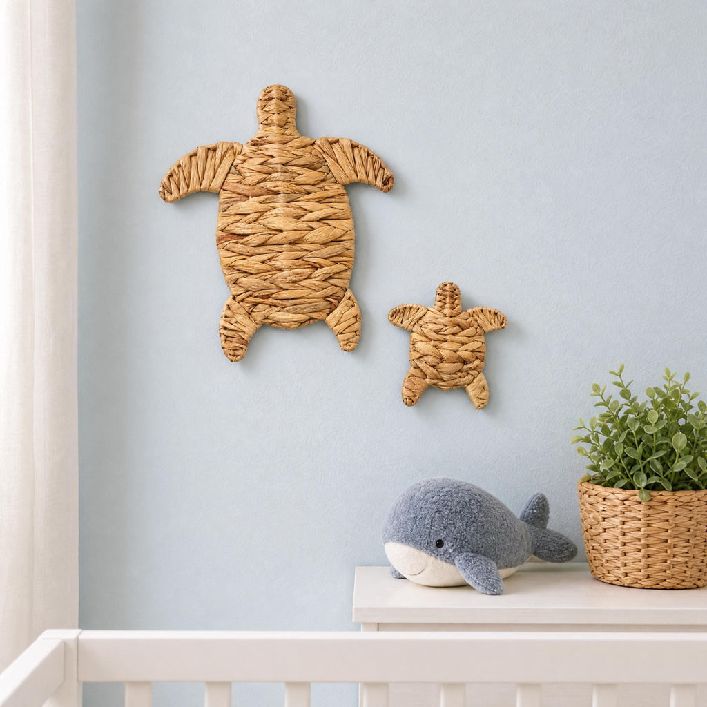 Handmade woven water hyacinth sea turtle wall decor, one large and one small turtle set, hung on a coastal nursery wall, beach ocean baby room decor