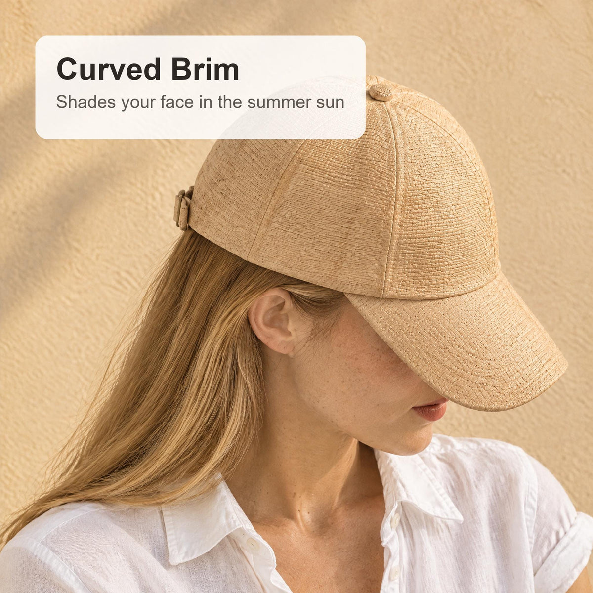 Side view of the raffia straw cap with the curved brim pulled low for sun shade