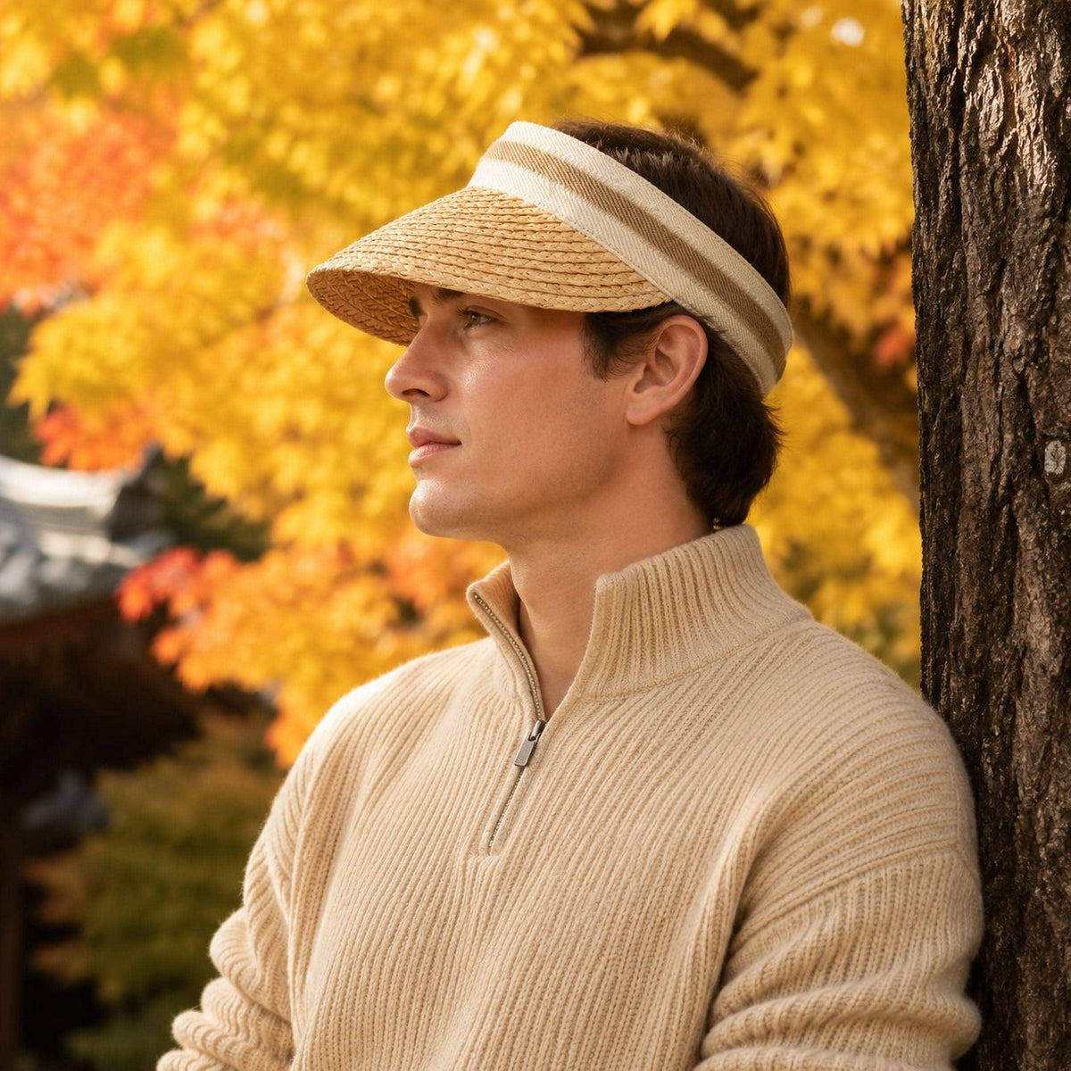 Man wearing a unisex raffia straw sun visor with striped band in an autumn park