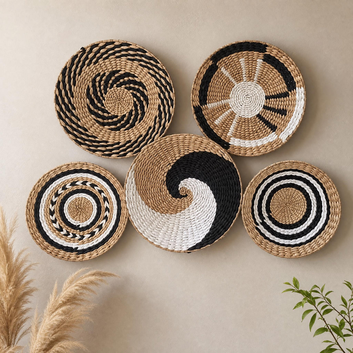 Handmade cattail wall basket set of 5 with swirl, ring and geometric patterns on a beige wall