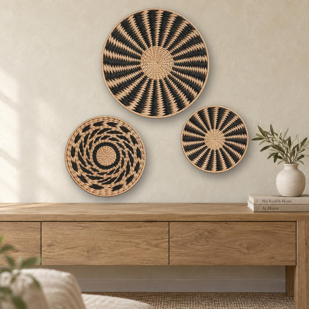 Set of 3 handwoven cattail wall baskets in black and natural tan, boho wall art above an oak console table