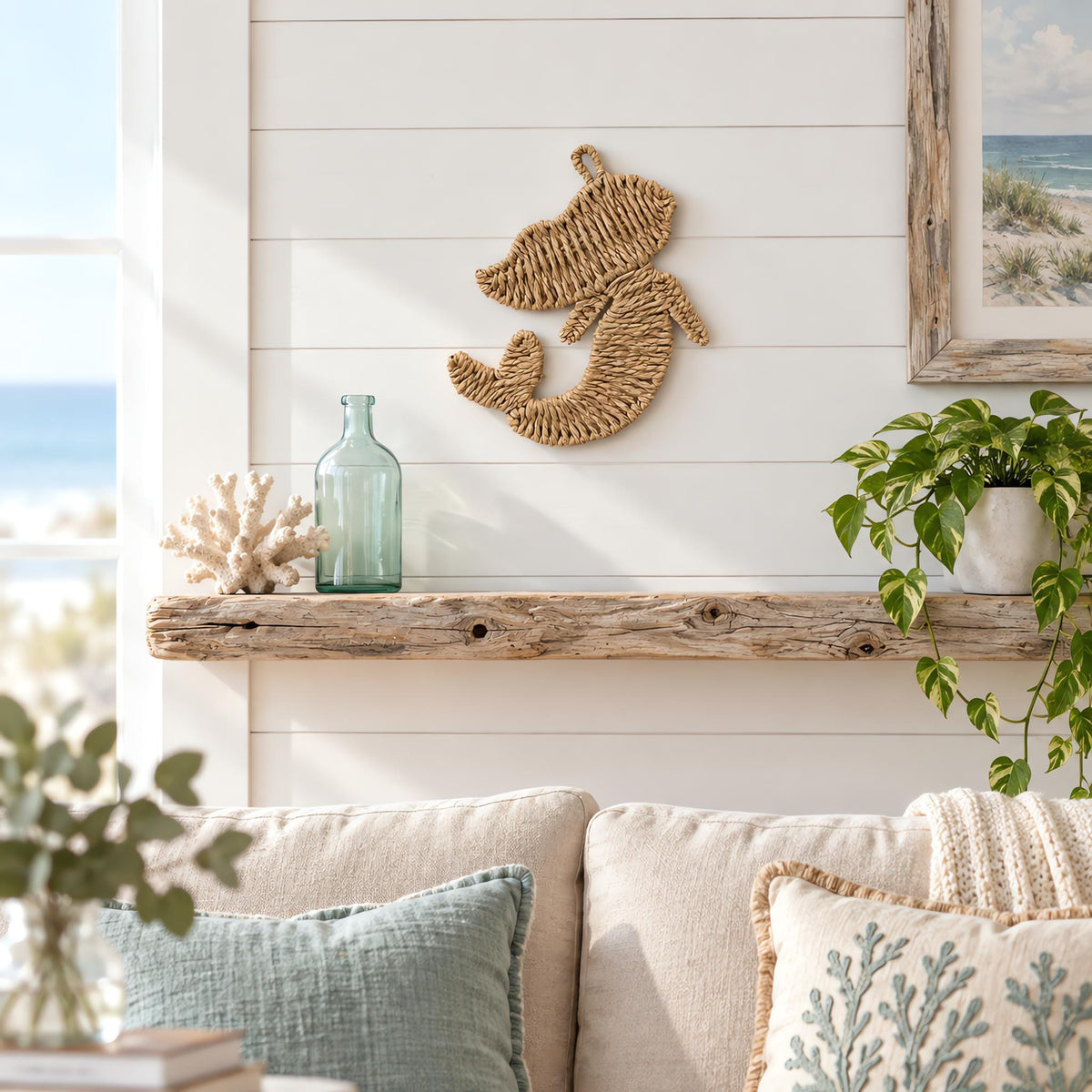 Woven paper rope mermaid wall decor styled on a white shiplap wall in a coastal living room