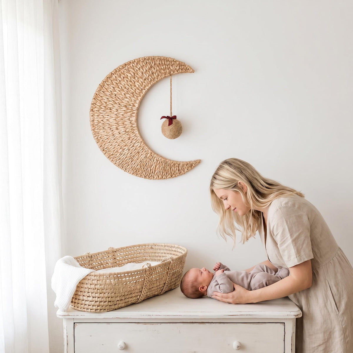 Handmade woven moon wall decor with a christmas ball ornament hanging above a nursery changing table, option Xmas Ball