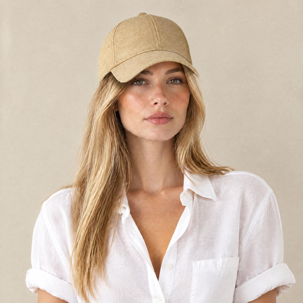 Woman wearing the handmade natural raffia straw baseball cap, front view