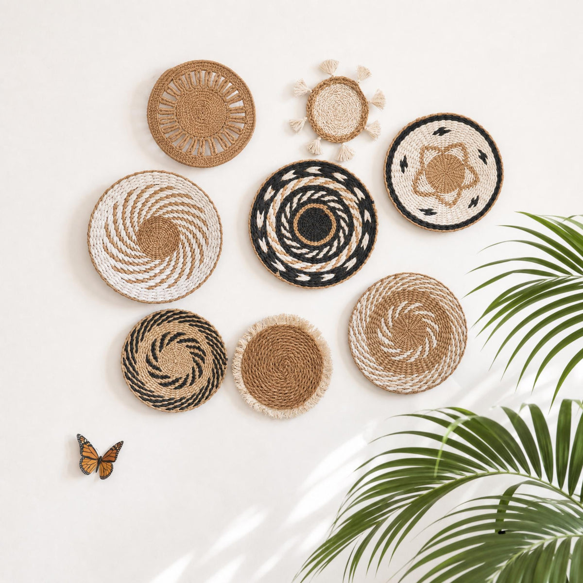 Set of 8 handwoven cattail wall baskets with swirl, ring, tassel and fringe designs, boho round wall art flat lay